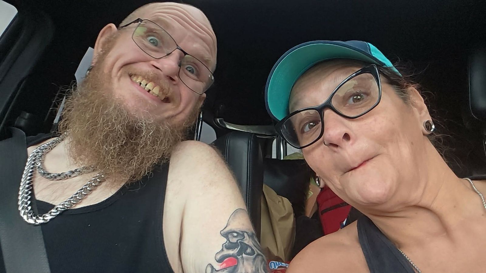 Tank and Sandra sharing a playful car selfie