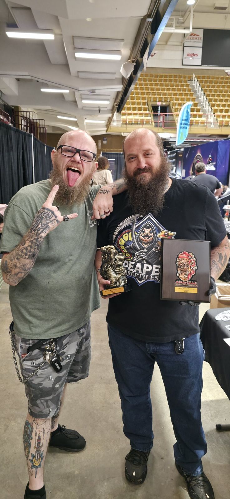 Tank and a fellow artist holding awards at the Asheville Tattoo Arts Festival