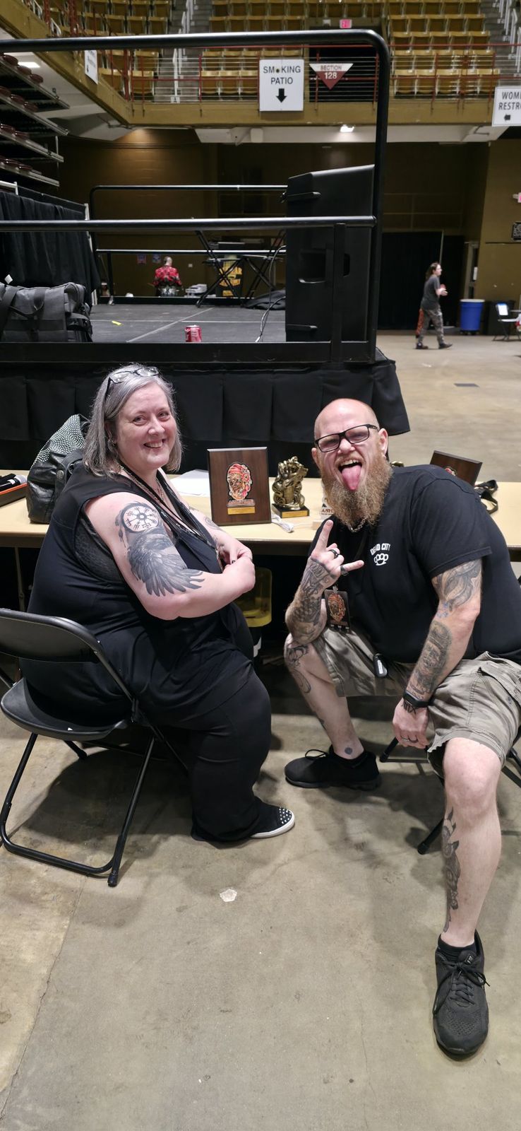 Tank and a fellow convention attendee celebrating beside award trophies
