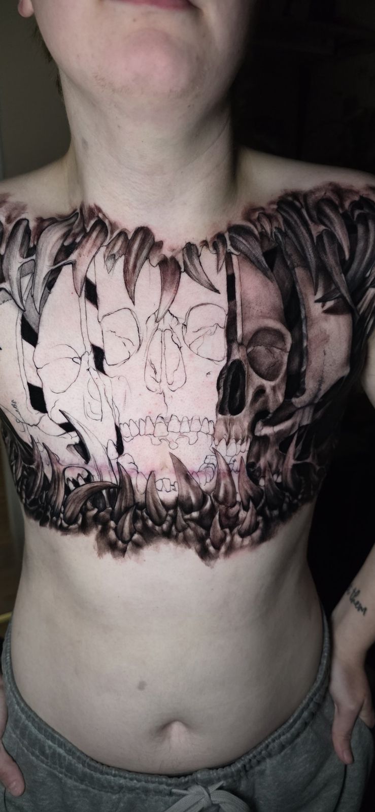 Large in-progress skull composition across the chest